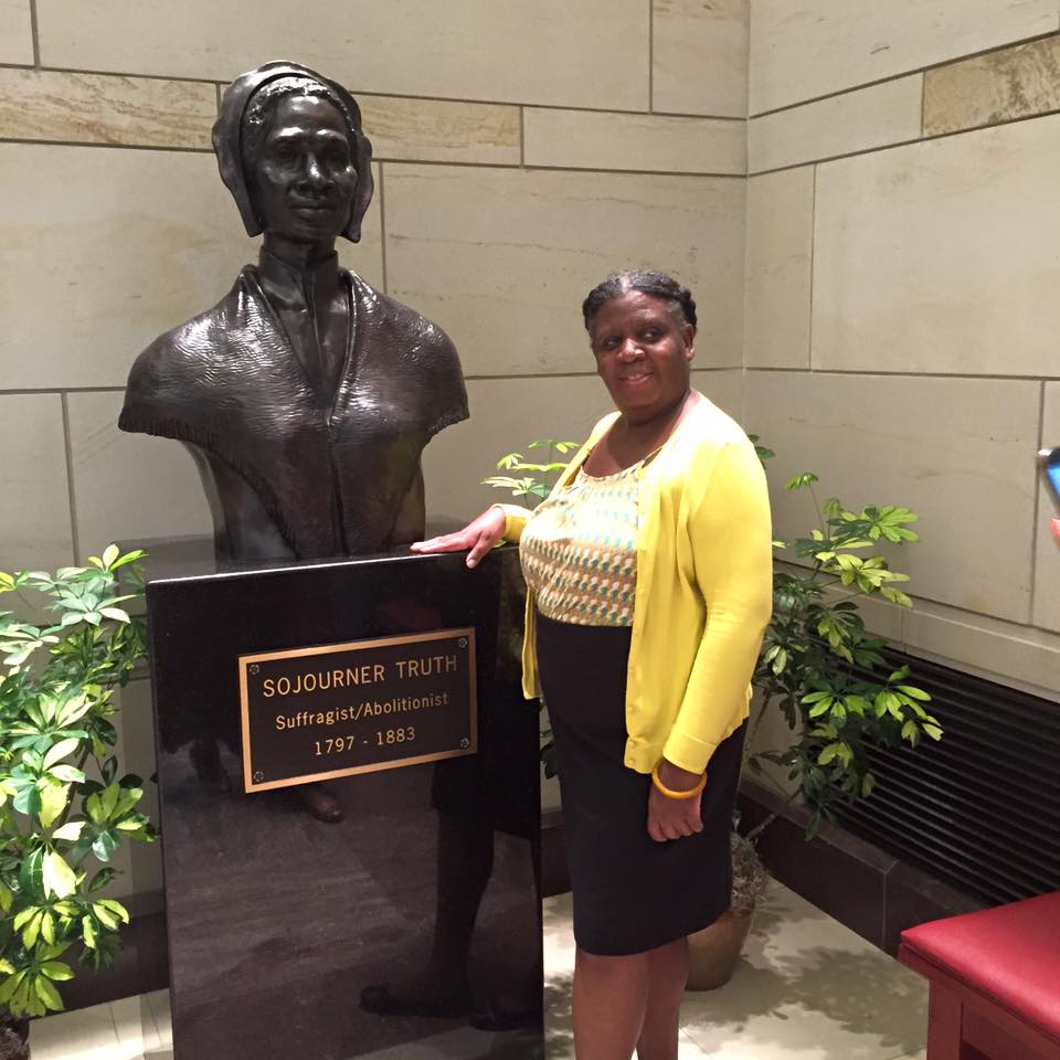 Jan Robinson Flint Standing next to a Sojourner Truth plaque