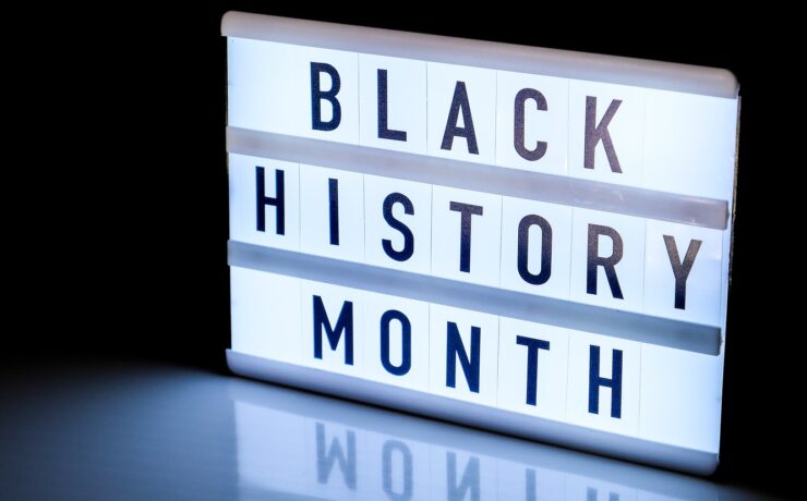 Lightbox with text BLACK HISTORY MONTH on dark black background with mirror reflection. Message