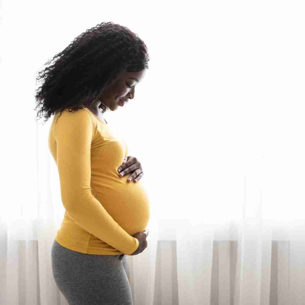 Pregnant black woman thinking about the challenges in getting a mortgage while on maternity leave