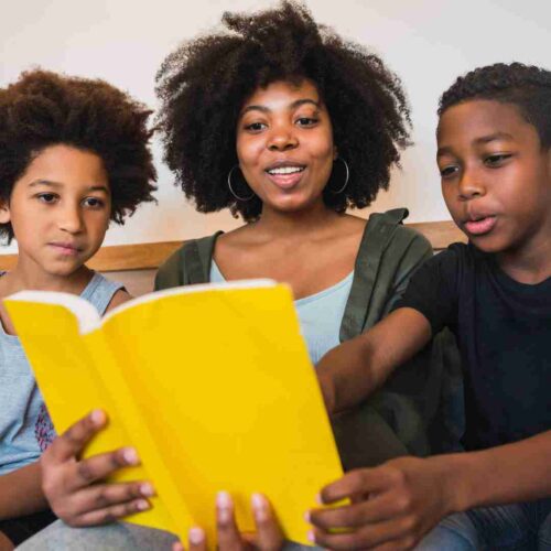 Black woman reading to her children