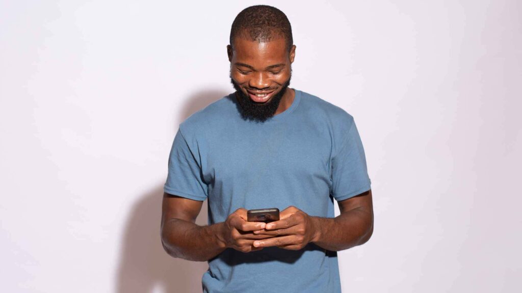 Young black man looking at a mobile device